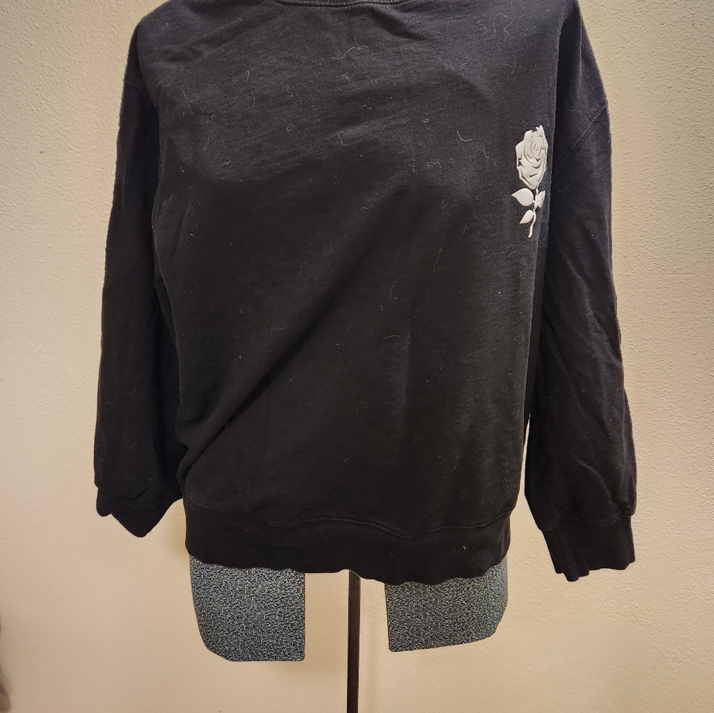 Plain black sweater with rose on front